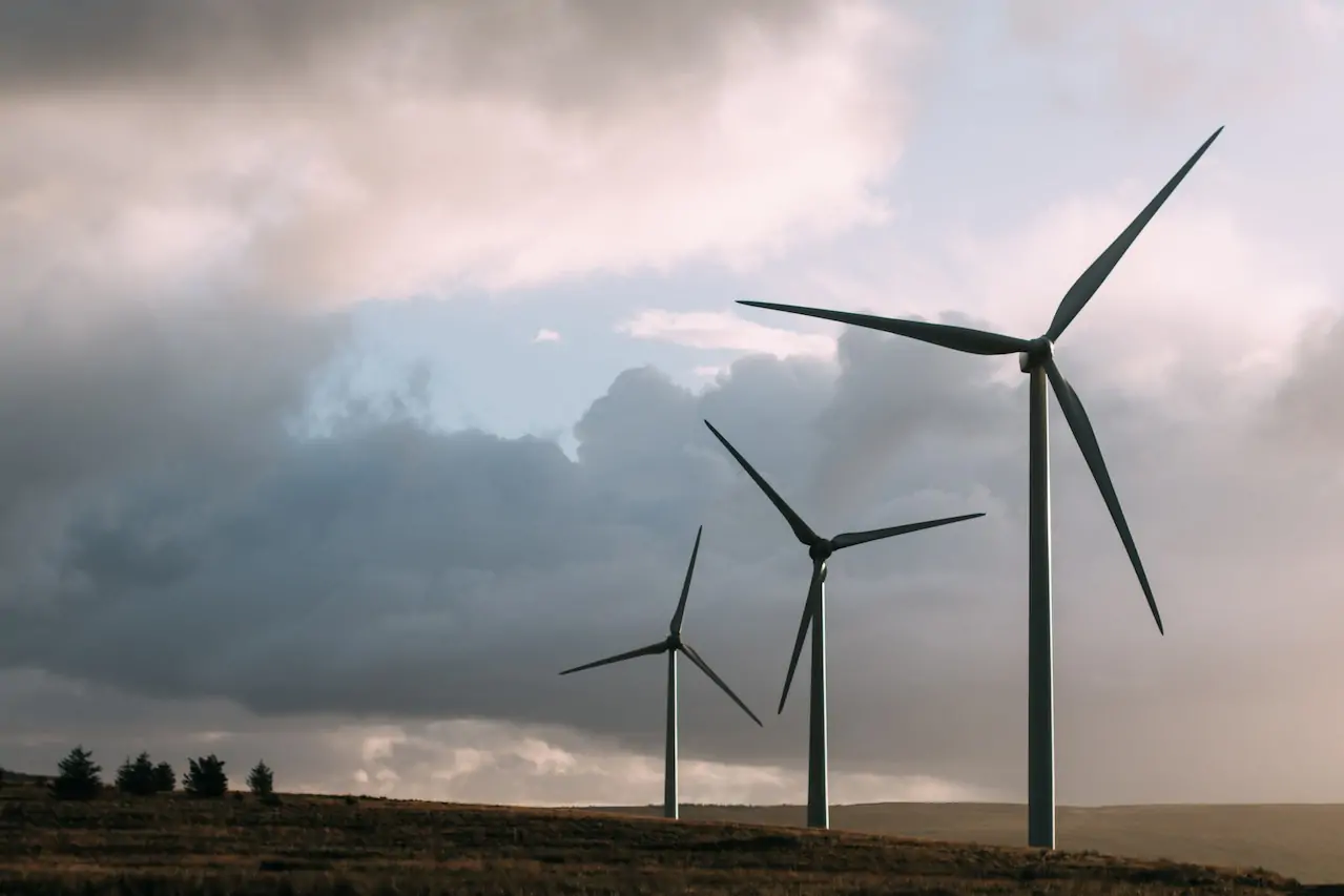 landscape with clouds in the sky and windmills